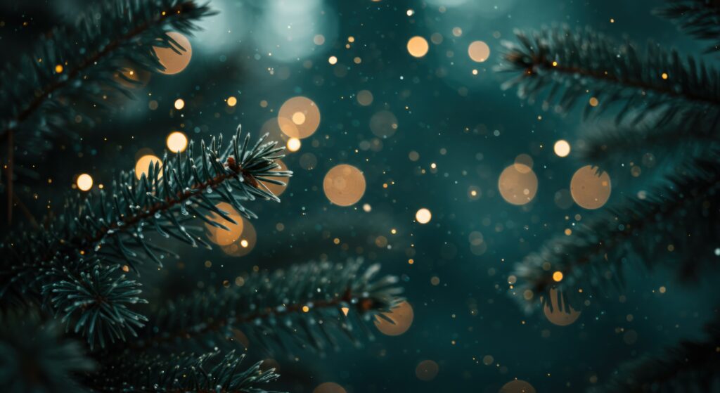 A festive background image of dark green evergreen branches with soft, glowing golden lights and bokeh effects.